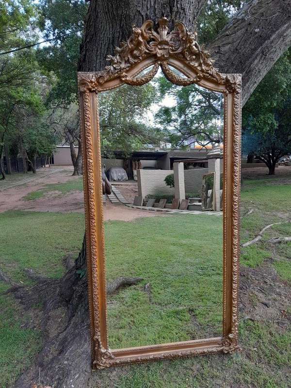 A French Rococo Style Ornately Carved & Gilded Bevelled Mirror