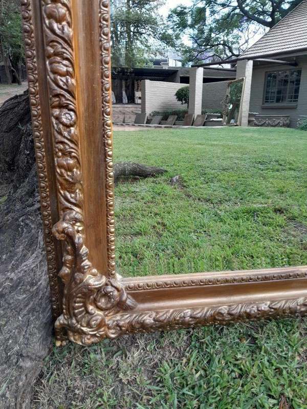 A French Rococo Style Ornately Carved & Gilded Bevelled Mirror