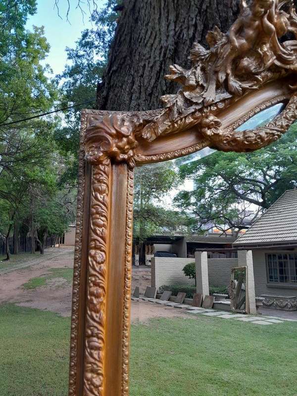 A French Rococo Style Ornately Carved & Gilded Bevelled Mirror