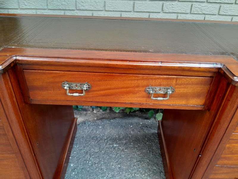 An Antique Victorian Mahogany Desk With Tooled Leather Top