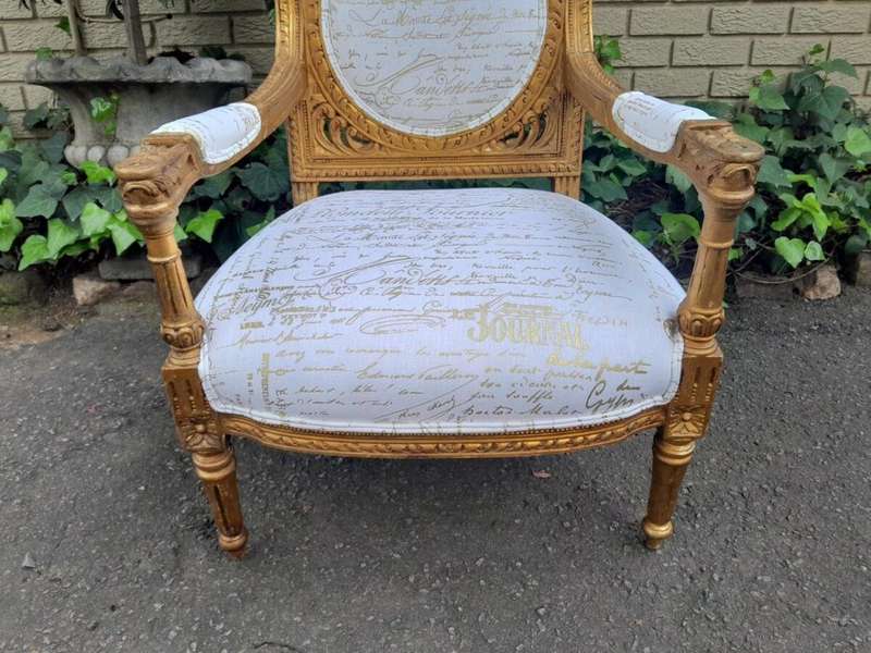 A 20th Century Pair Of French Ornately Carved And Gilded Armchairs