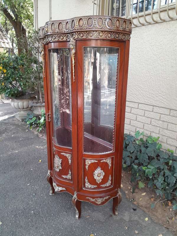 An Antique 20th Century French Ornate Style Mahogany Vitrine with Metal Mounts