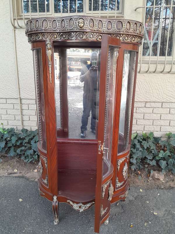 An Antique 20th Century French Ornate Style Mahogany Vitrine with Metal Mounts
