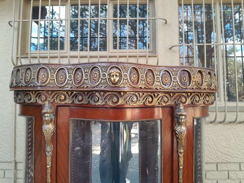An Antique 20th Century French Ornate Style Mahogany Vitrine with Metal Mounts