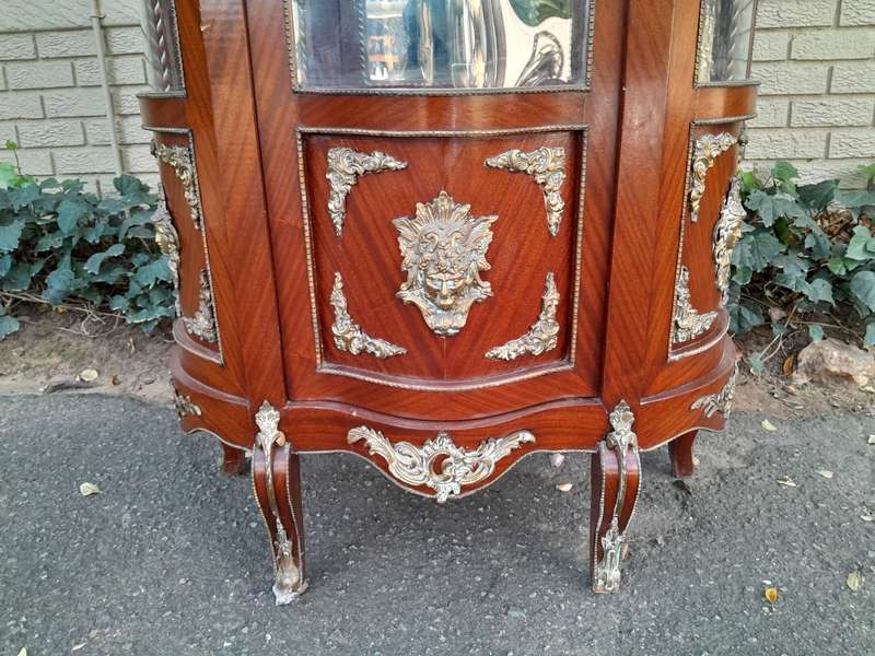 An Antique 20th Century French Ornate Style Mahogany Vitrine with Metal Mounts