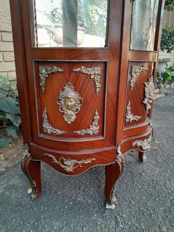 An Antique 20th Century French Ornate Style Mahogany Vitrine with Metal Mounts