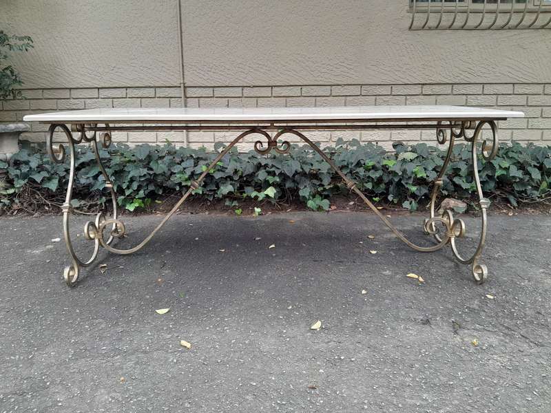 A  French Style Wrought Iron Console / Dining Table in an Antique Gold Finish with Cream Marble T...
