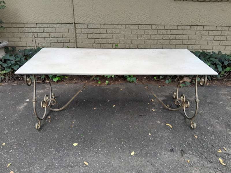 A  French Style Wrought Iron Console / Dining Table in an Antique Gold Finish with Cream Marble T...
