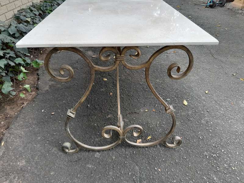 A  French Style Wrought Iron Console / Dining Table in an Antique Gold Finish with Cream Marble T...