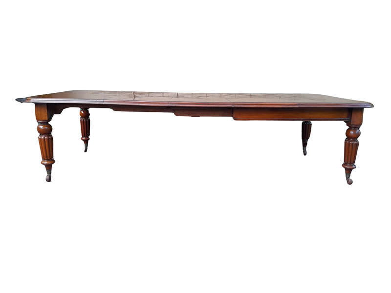 An Antique Edwardian Extending Dining Table with Heavily Carved Legs on Castors and with Crank Ha...