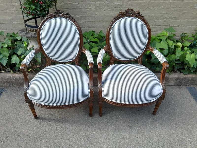 A 20th Century French Pair Of Gilded Mahogany Arm Chairs Upholstered In A Ticking Fabric 