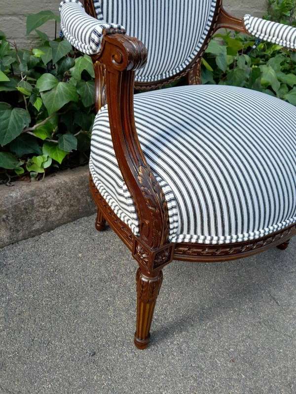 A 20th Century French Pair Of Gilded Mahogany Arm Chairs Upholstered In A Ticking Fabric 