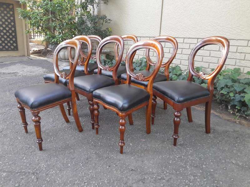 A 20th Century Set of Eight Victorian Style Mahogany Dining Chairs Upholstered in Leather