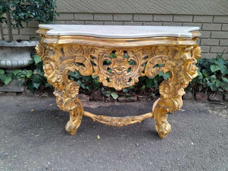 A 20th Century Heavily Carved and Hand Gilded with Gold Leaf Console Table with Cream Marble Top