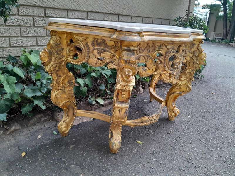 A 20th Century Heavily Carved and Hand Gilded with Gold Leaf Console Table with Cream Marble Top
