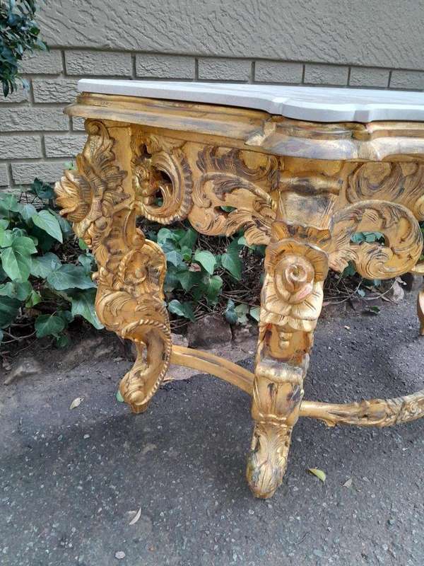 A 20th Century Heavily Carved and Hand Gilded with Gold Leaf Console Table with Cream Marble Top
