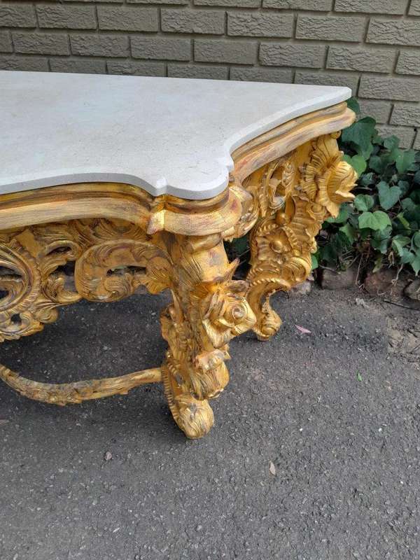 A 20th Century Heavily Carved and Hand Gilded with Gold Leaf Console Table with Cream Marble Top