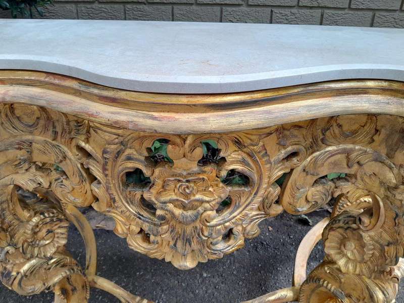 A 20th Century Heavily Carved and Hand Gilded with Gold Leaf Console Table with Cream Marble Top