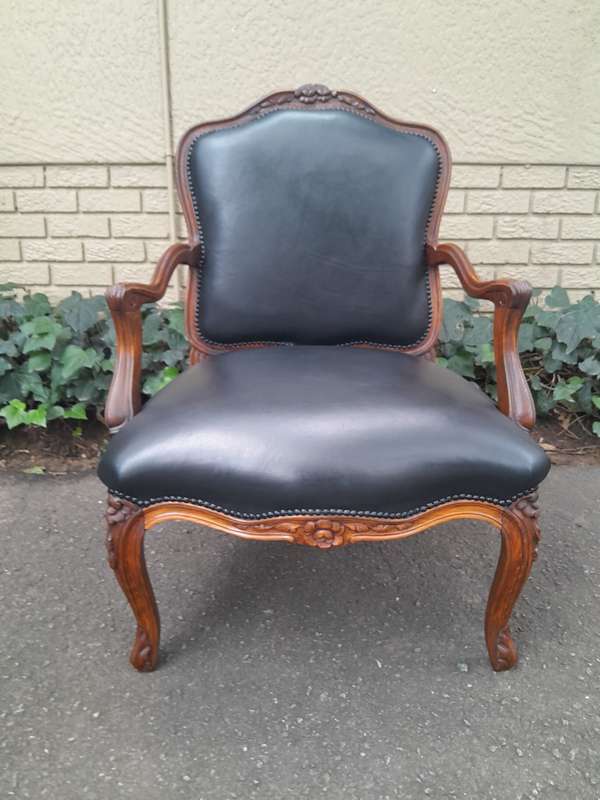 A 20th Century Pair or Carved Mahogany Armchairs Upholstered In Leather