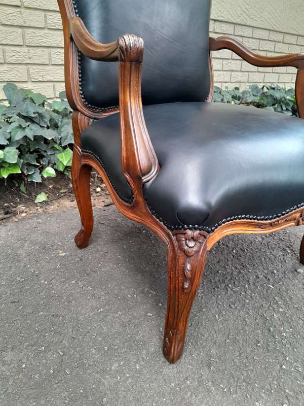 A 20th Century Pair or Carved Mahogany Armchairs Upholstered In Leather