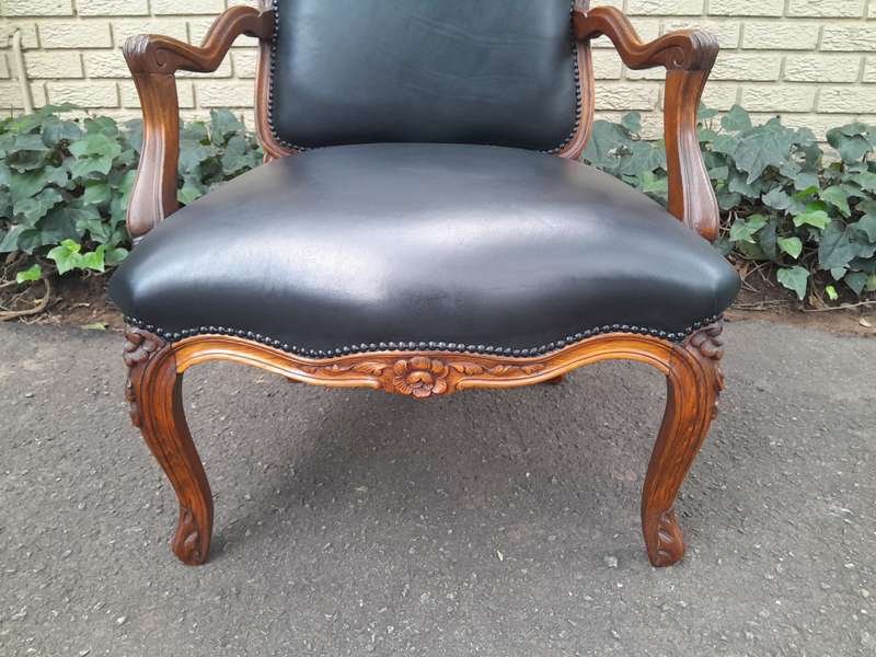 A 20th Century Pair or Carved Mahogany Armchairs Upholstered In Leather