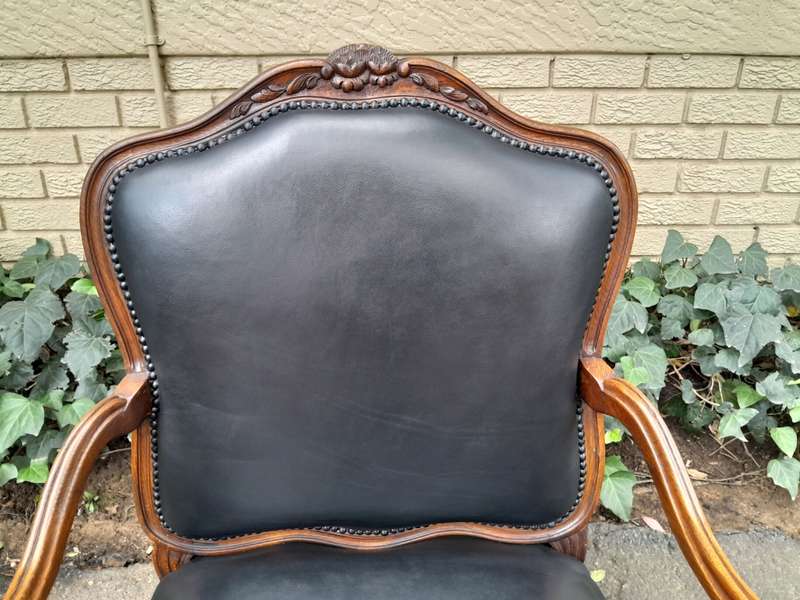 A 20th Century Pair or Carved Mahogany Armchairs Upholstered In Leather