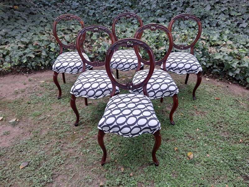 An Antique Victorian Walnut Set of Six Ornately Carved Chairs