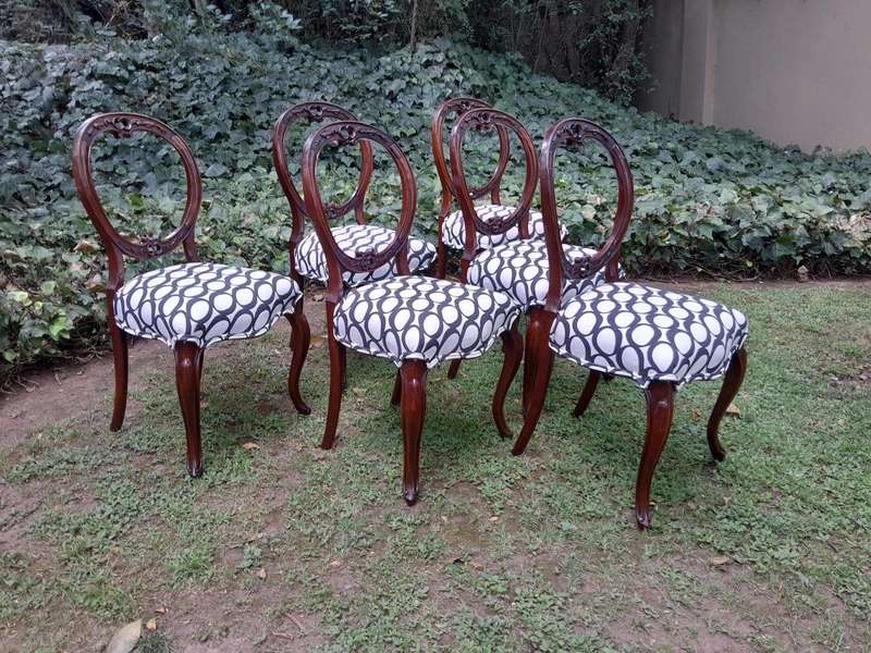 An Antique Victorian Walnut Set of Six Ornately Carved Chairs