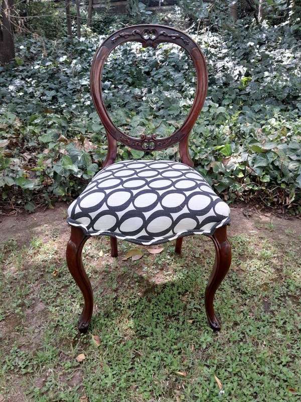 An Antique Victorian Walnut Set of Six Ornately Carved Chairs