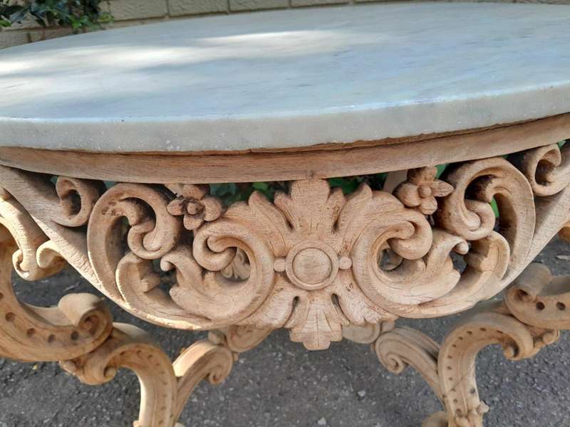 A20th Century Rococo Style Heavily Carved Teak Table with White Marble Top in a Contemporary Blea...