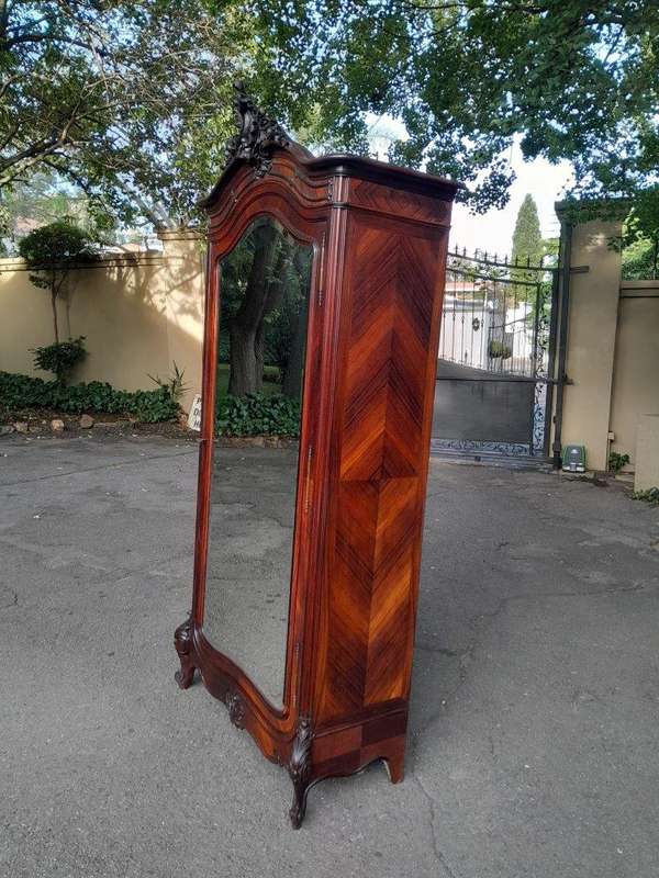 An Early 20th Century French Carved Rosewood Armoire with Bevelled Mirror and Lock and Key