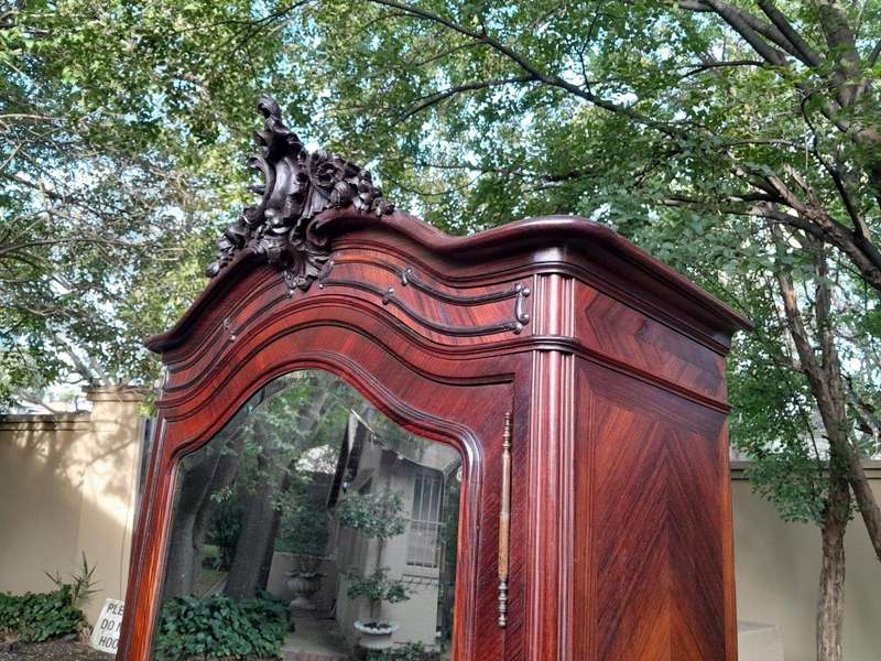 An Early 20th Century French Carved Rosewood Armoire with Bevelled Mirror and Lock and Key