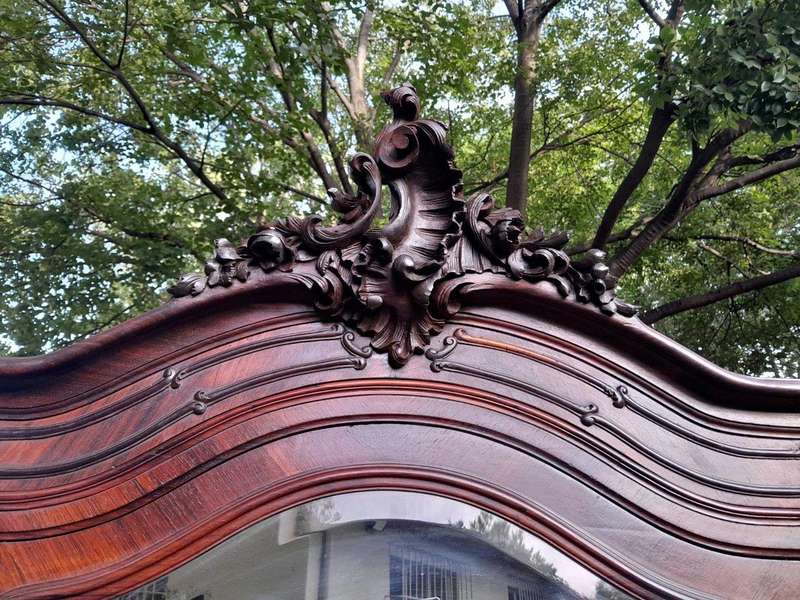 An Early 20th Century French Carved Rosewood Armoire with Bevelled Mirror and Lock and Key