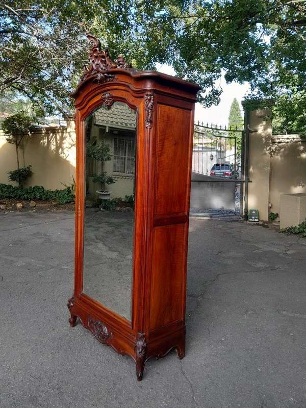 A 20TH Century Circa 1900s French Carved Mahogany Armoire with Bevelled Mirror and Five Shelves