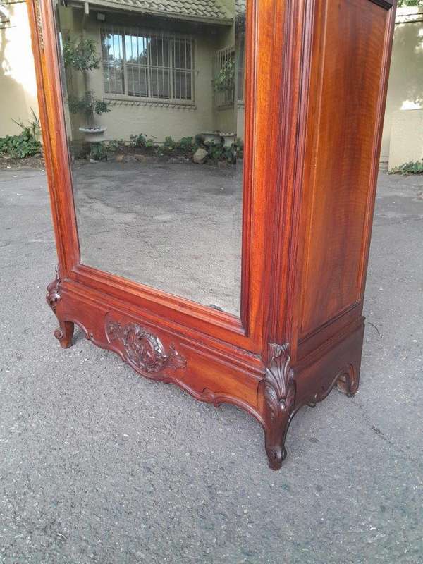 A 20TH Century Circa 1900s French Carved Mahogany Armoire with Bevelled Mirror and Five Shelves