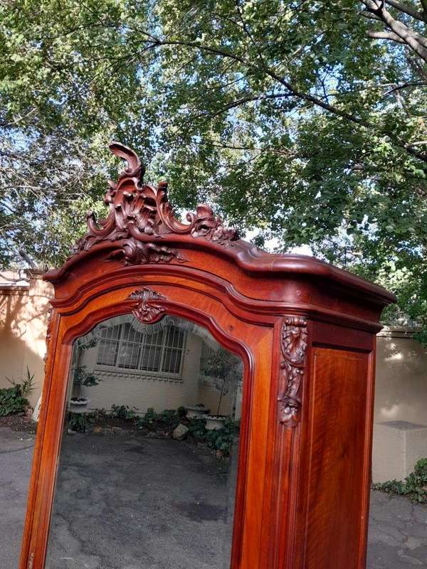 A 20TH Century Circa 1900s French Carved Mahogany Armoire with Bevelled Mirror and Five Shelves