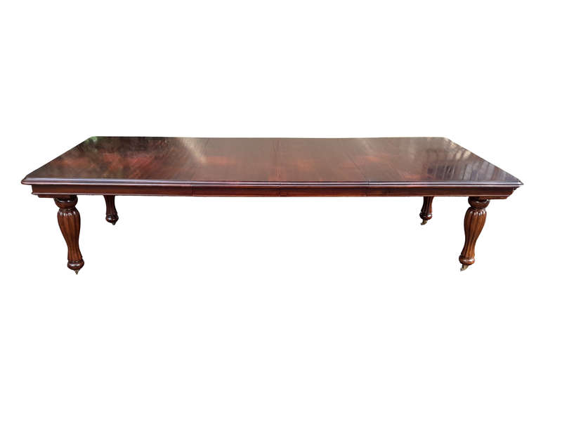 A 20Th Century Mahogany Extending Table with Two Extensions, on Brass Castors with Crank Handle