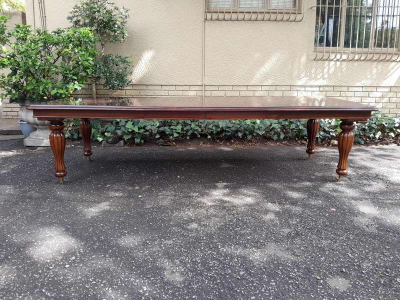 A 20Th Century Mahogany Extending Table with Two Extensions, on Brass Castors with Crank Handle