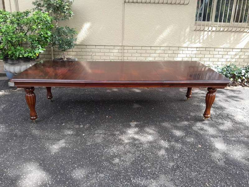 A 20Th Century Mahogany Extending Table with Two Extensions, on Brass Castors with Crank Handle