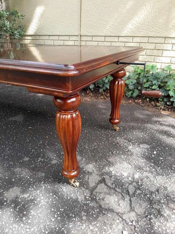A 20Th Century Mahogany Extending Table with Two Extensions, on Brass Castors with Crank Handle