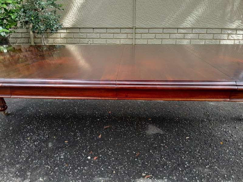 A 20Th Century Mahogany Extending Table with Two Extensions, on Brass Castors with Crank Handle