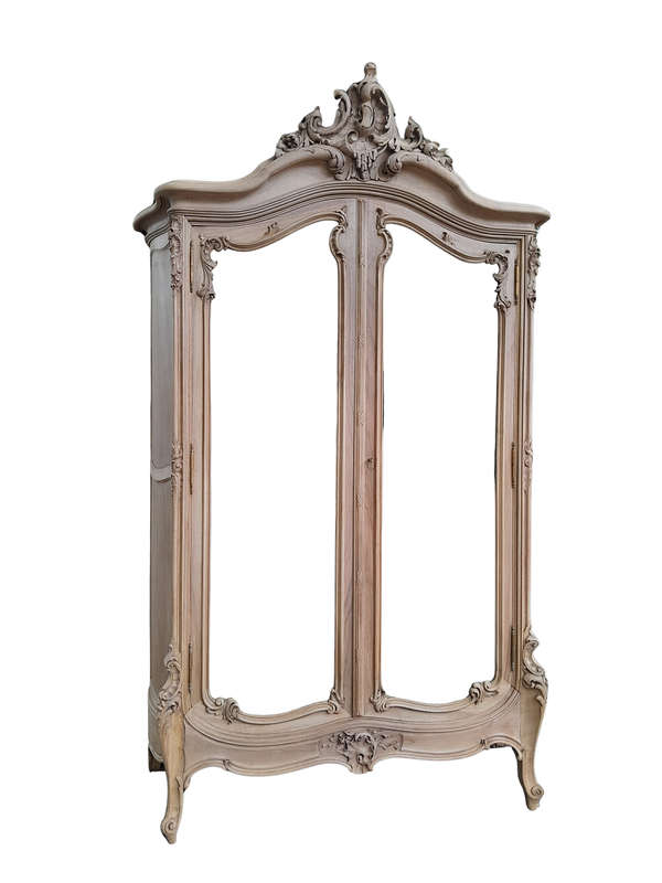 An Antique French Heavily Carved Oakd Two Door Armoire with Bevelled Mirrors and Four Shelves
