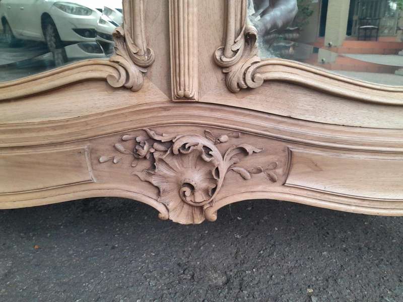 An Antique French Heavily Carved Oakd Two Door Armoire with Bevelled Mirrors and Four Shelves