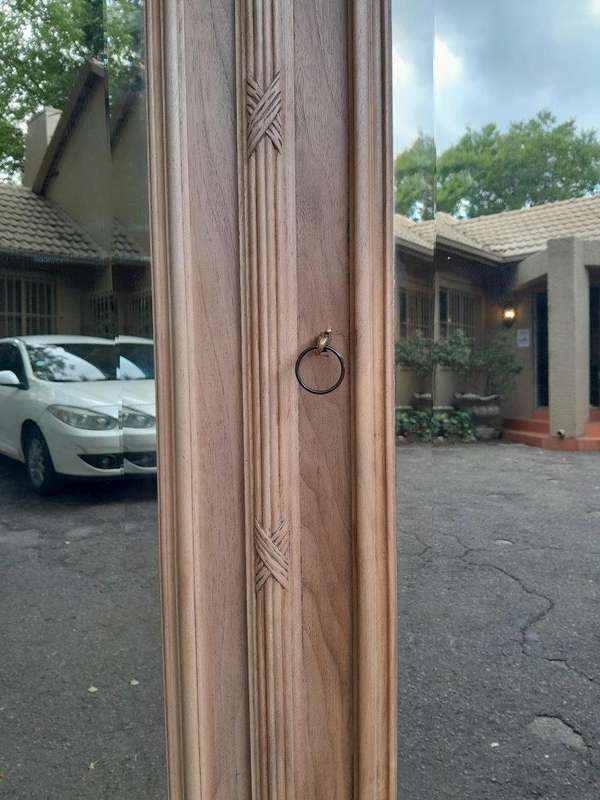 An Antique French Heavily Carved Oakd Two Door Armoire with Bevelled Mirrors and Four Shelves