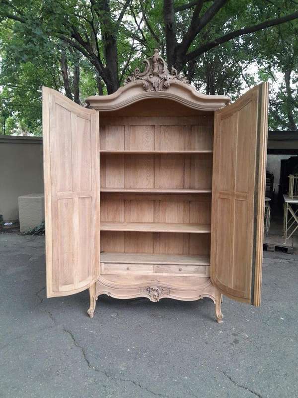 An Antique French Heavily Carved Oakd Two Door Armoire with Bevelled Mirrors and Four Shelves