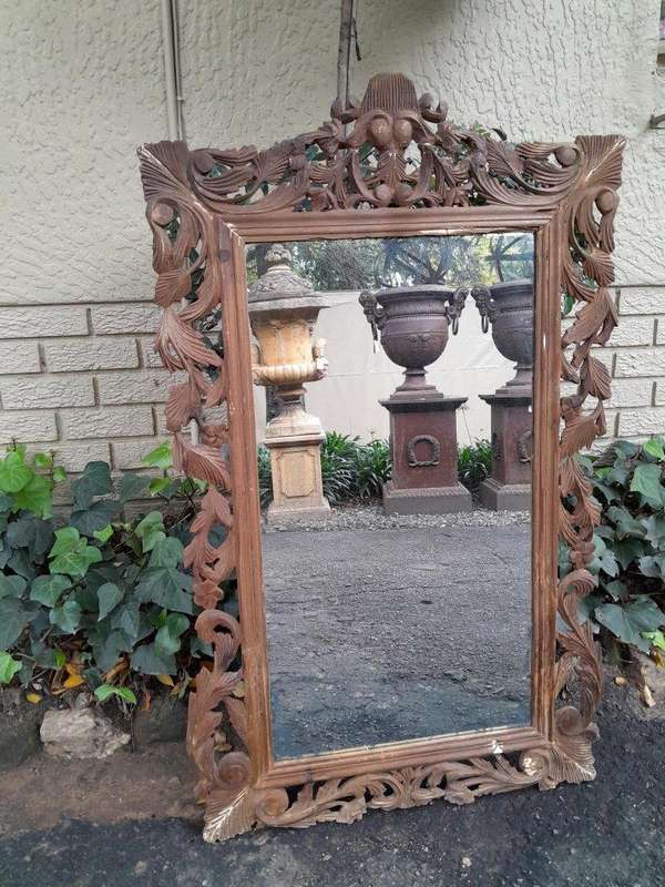 An Ornately Carved And Bleached To A Contemporary Finish Wooden Mirror