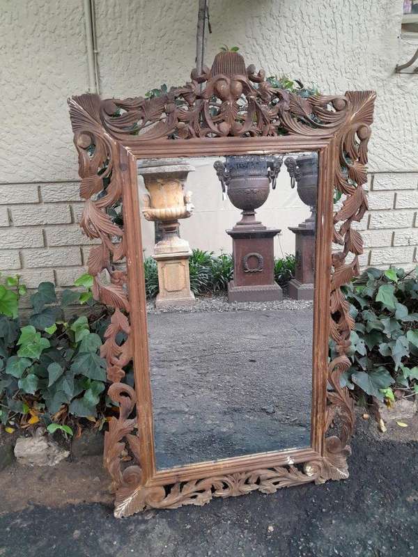 An Ornately Carved And Bleached To A Contemporary Finish Wooden Mirror