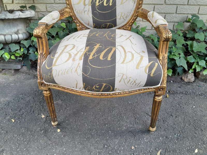 A Pair of French Style Carved and Gilded Armchairs Upholstered in a Custom-Made Hand Printed Fabr...