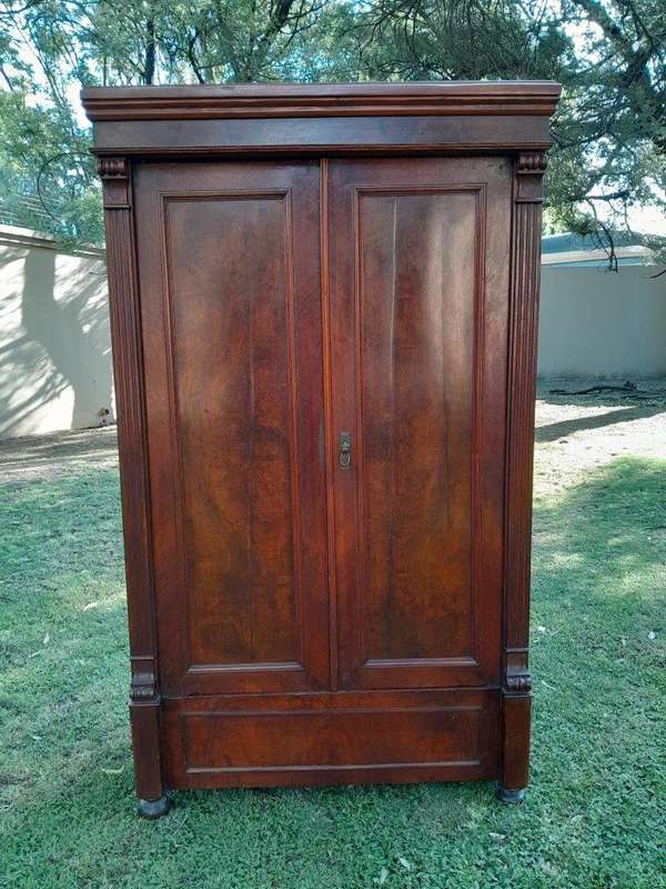 A Mid  20th Century Stinkwood Linen Press with Four Original Shelves and Drawers
