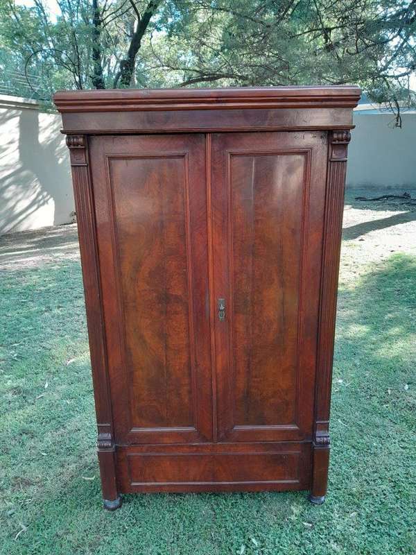 A Mid  20th Century Stinkwood Linen Press with Four Original Shelves and Drawers